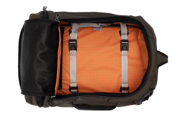An open Techonaut 30 with a Ursa (brown) exterior and a Zest (orange with white grid) interior.